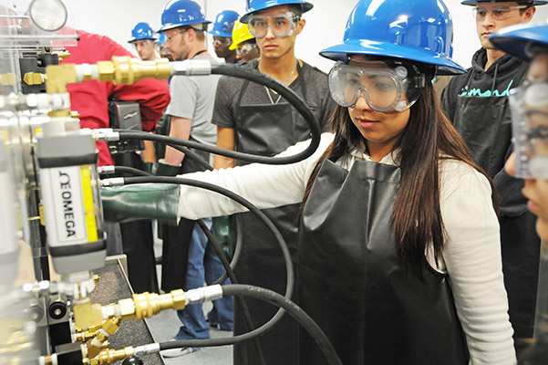 Students learning in a manufacturing environment