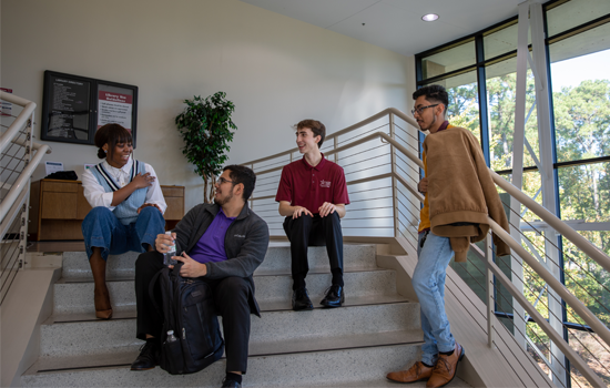Group of students sitting on stairs 