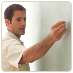 Instructor writing on chalkboard