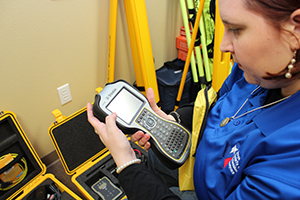 Amy Maddox using land surveying equipment