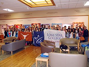 LSC-Montgomery students at Uniersity of Texas holding LSC-Montgomery and UT banners