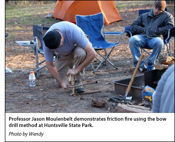 Professor Jason Moulenbelt demonstrates friction fire using the bow drill method at Huntsville State Park