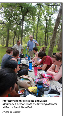 Professors Ronnie Nespeca and Jason Moulenbelt demonstrate the filtering of water at Brazos Bend State Park 