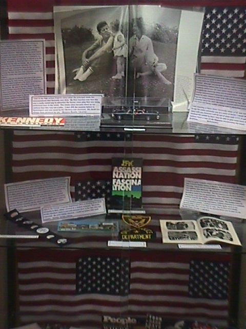 A close up of the Life magazine spread and a model of the open car in which the president was riding when he was shot. 