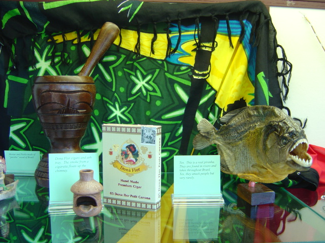 a mortar and pestle, a personal ash tray, a cigar box, and a mounted piranha