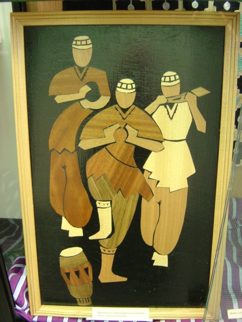 framed wood-inlay depicting musicians