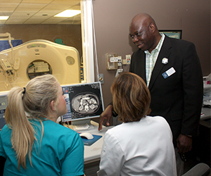 Dr. Francis Ozor and students using the computed tomography scan
