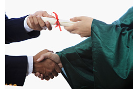 Graduation with handshake and diploma