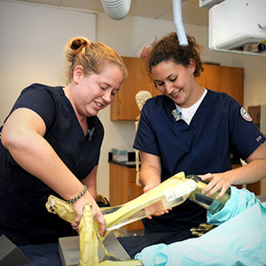 2 nursing studies studying a skeleton