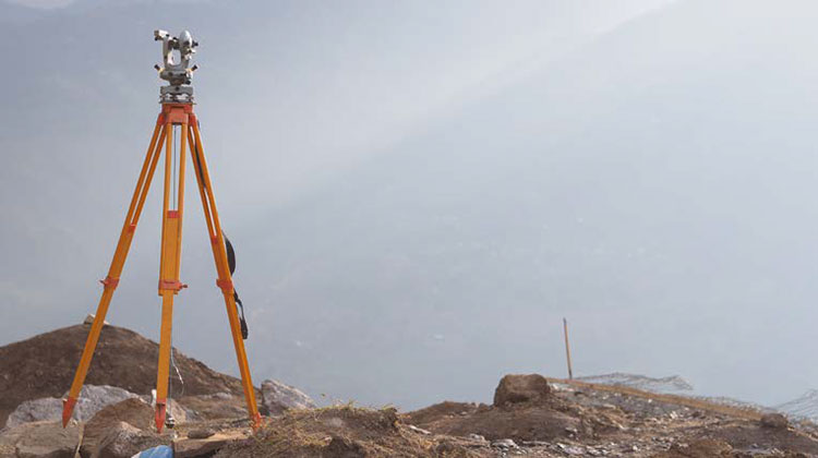Land surveying equipment on a tripod.