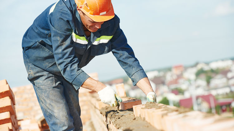 Construction worker laying bricks