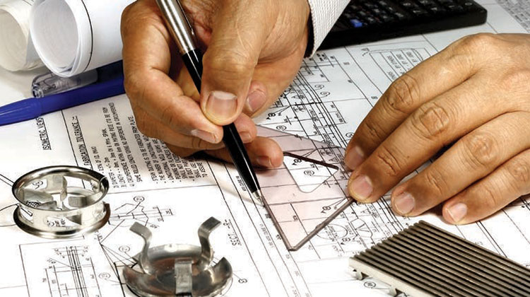 Hands drawing on blueprints.
