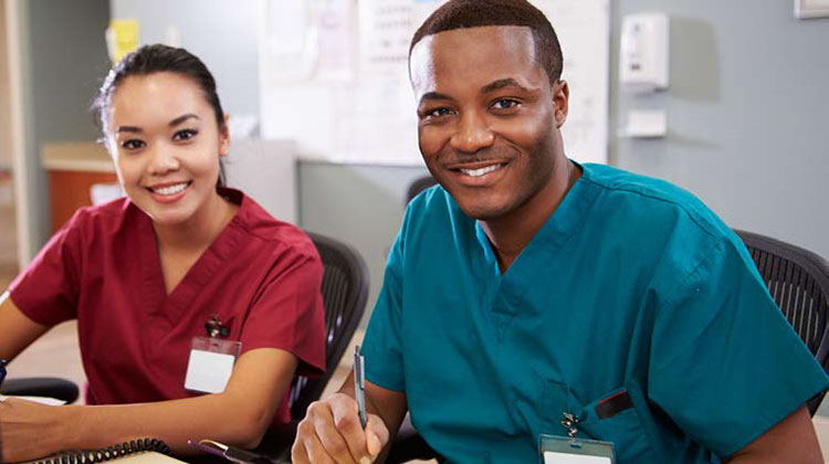 Two nurses sitting at a table