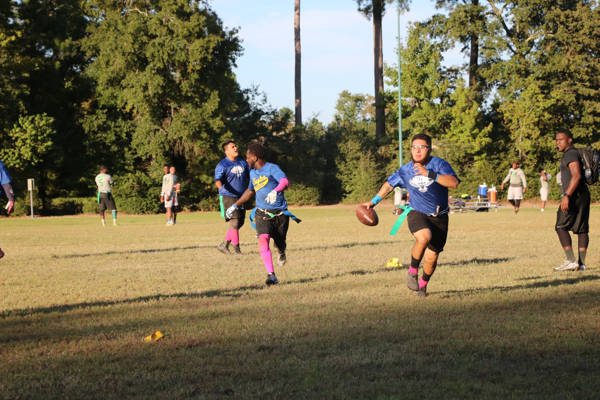Photo of student from two different teams playing flag football