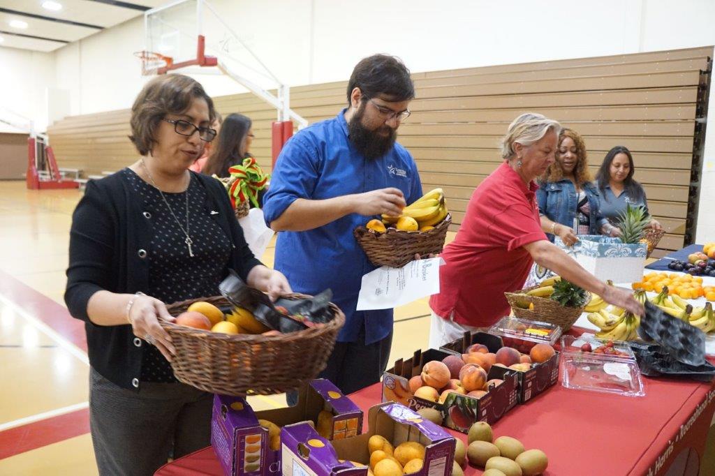 Photo of employees getting fruit for their departments