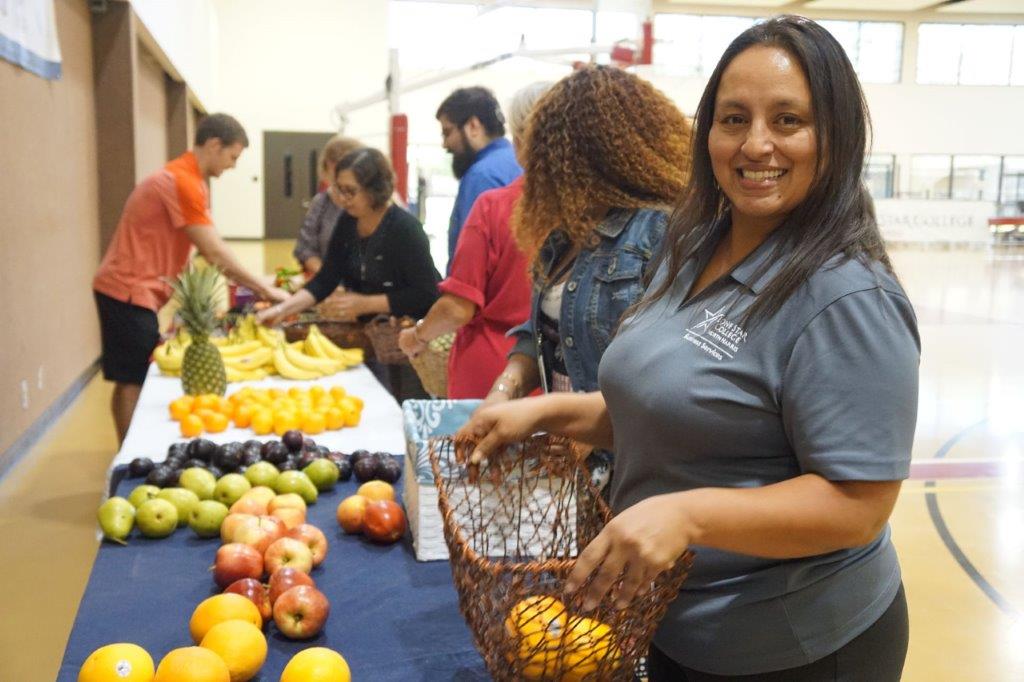 Photo of employees getting fruit for their departments