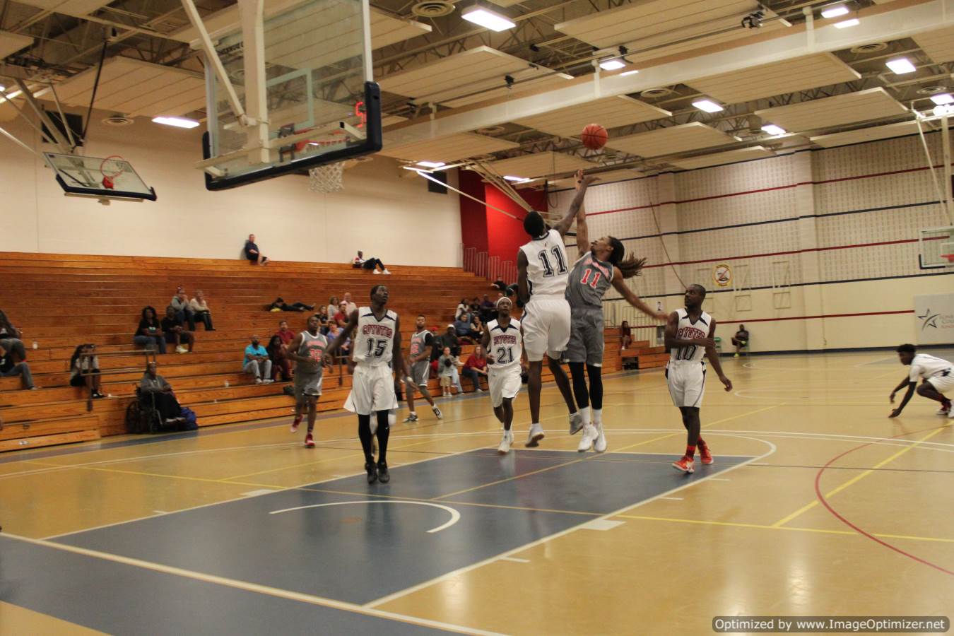 Photo of students from different teams playing basketball