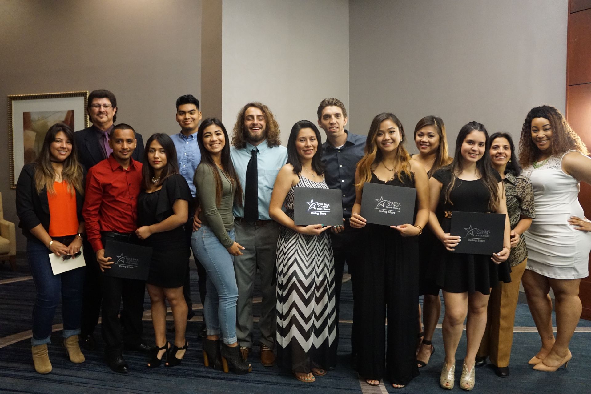 Photo of students and guests posing for photo holding awards