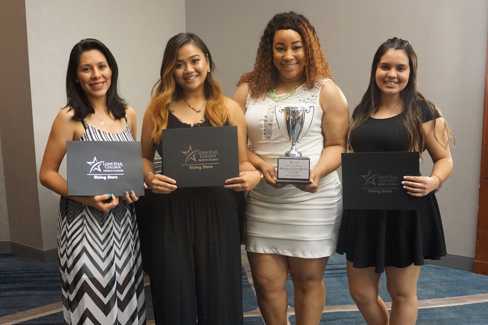 Photo of students posing for photo holding awards