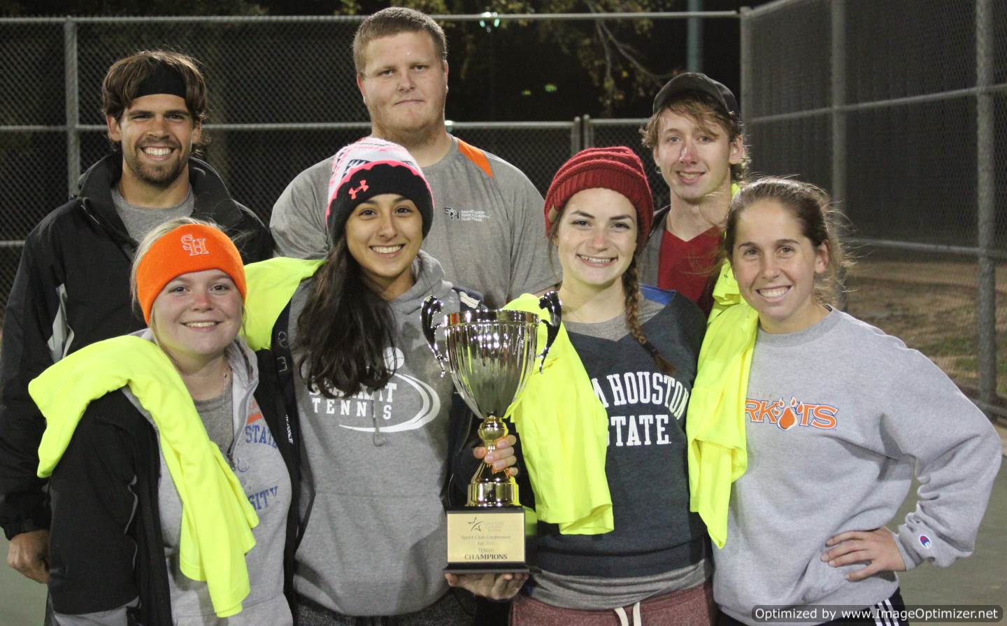 Photo of students from Sam Houston State University posing for a photo with a trophy