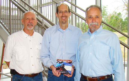 Kent Lucas, left, an Lone Star College-Montgomery human services major, helped put together an inspirational book written by 11 students in the program, and presented it to the human services faculty members, including Glen Killian (center), and Steve Lewis. Lucas will participate in a panel discussion about the book on Friday, March 4, at 11 a.m. in the General Academic Center, Room G102.