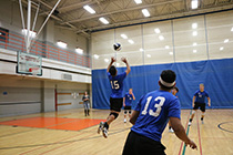 Photo of an action shot of the Men's Volleyball team