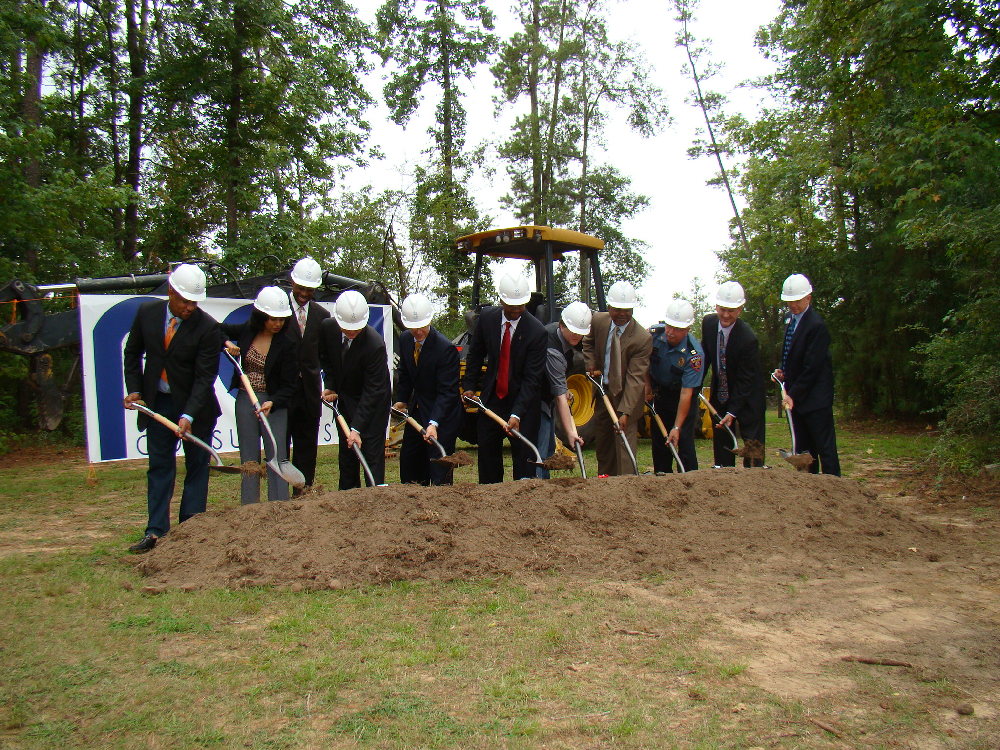 Participants shovel dirt as part of the groundbreaking ceremony for Lone Star College-Montgomerys new parking garage. From l. to r.: Patrick Johnson, general contractor, Johnson Group USA; Rashmi Murthy, Harrison Kornberg; James Harrison, Harrison Kornberg; Daniel Kornberg, Harrison Kornberg; Ed Shoemake, Jones Lang Lasalle; Dr. Austin Lane, president of LSC-Montgomery; Chris Baker, LSC-Montgomery student; Don Kerl, Diggs Construction; Charlie Soliz, LSC-Montgomery police captain; David Kaczynski, LSCS project director; and Jim Taylor, LSC-Montgomery vice president of administrative services.