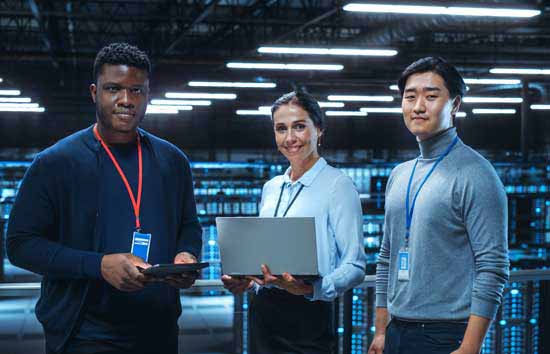 3 people standing in a datacenter