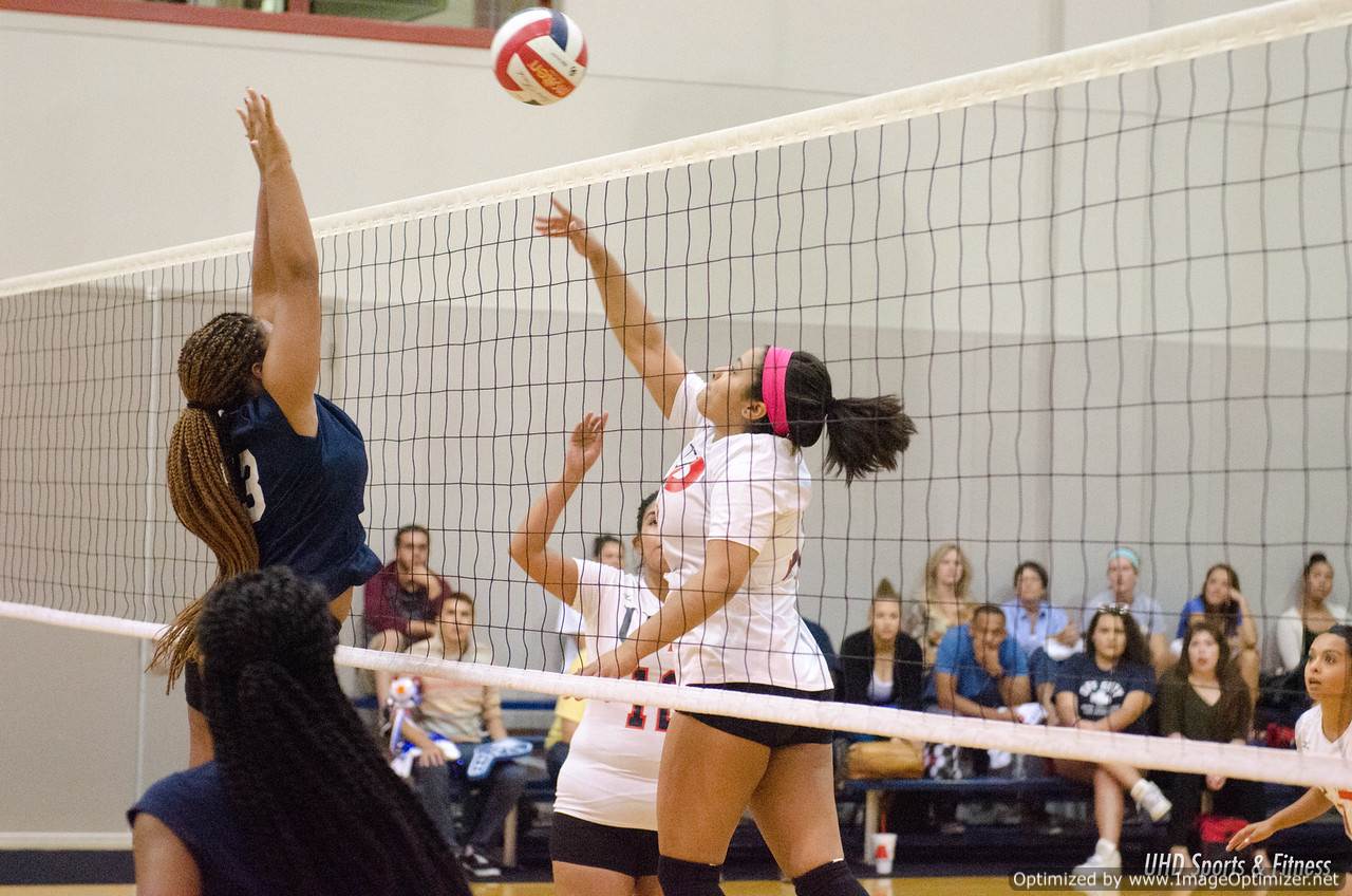 Photo of students from two different teams playing volleyball