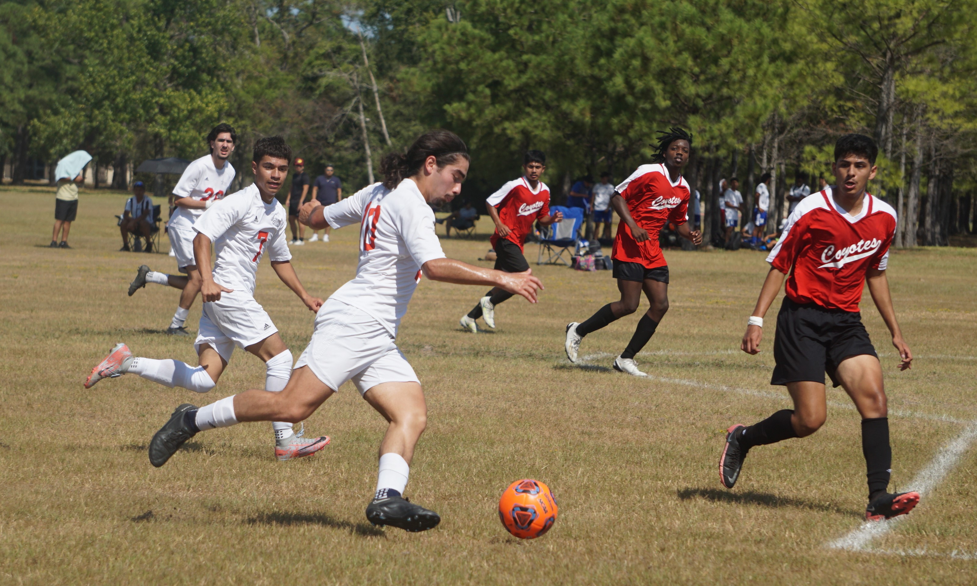 Photo of soccer players during a game red vs white