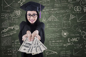 Graduate holding money in front of chalk board