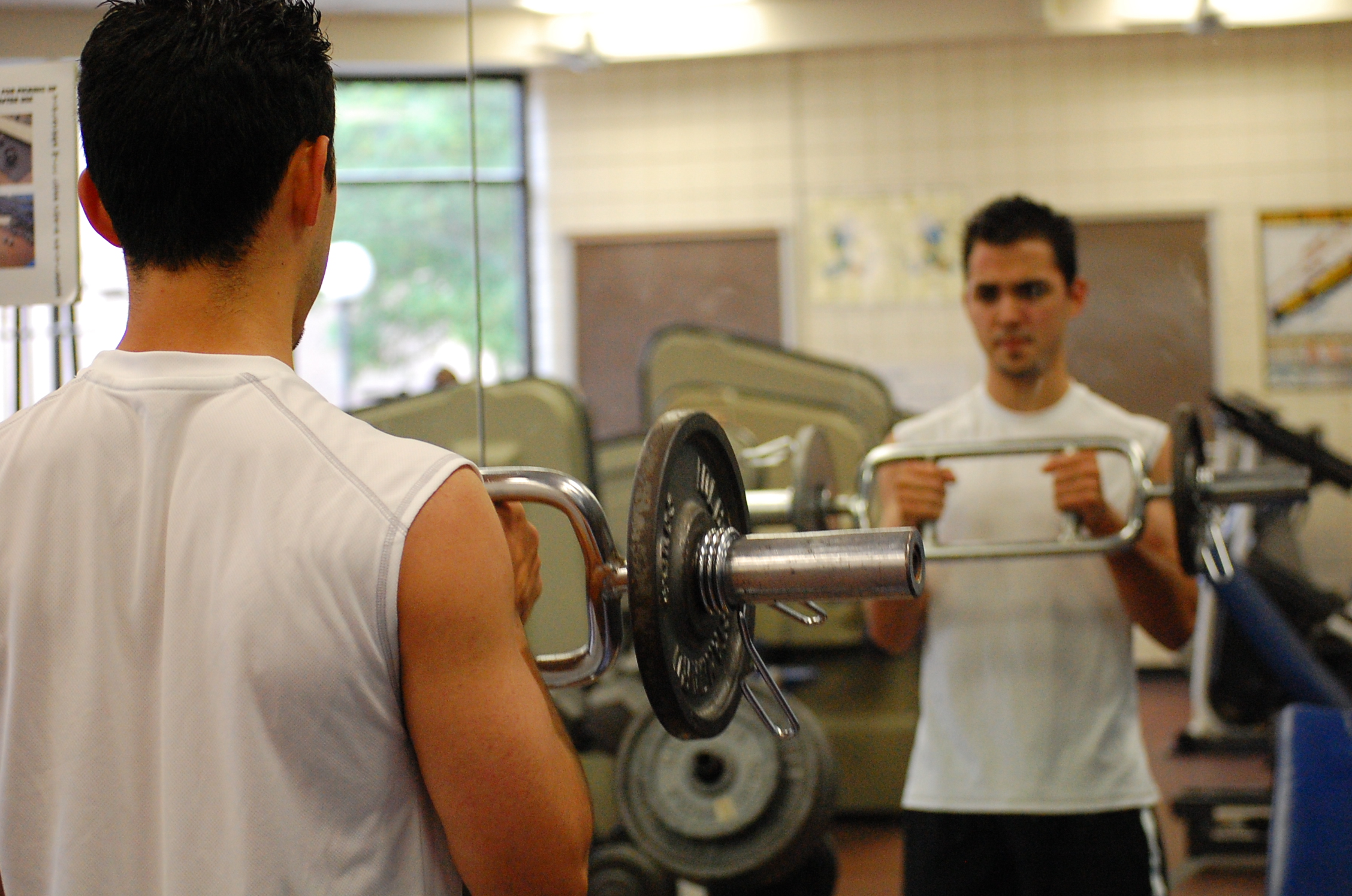 Photo of student lifting weights in the weight room