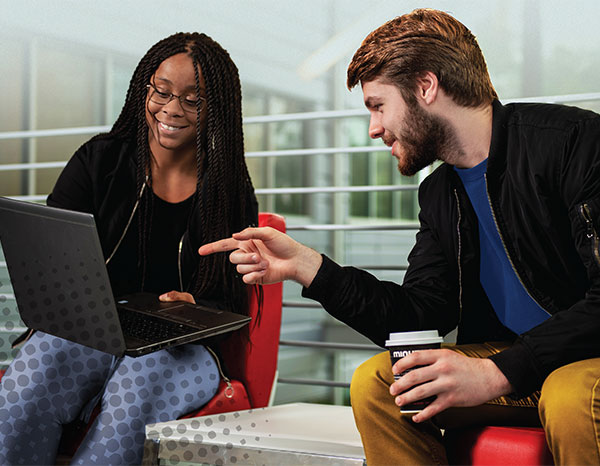 Two students and a laptop