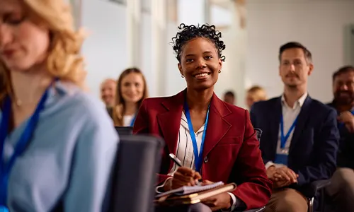 Happy employee sitting in a seminar