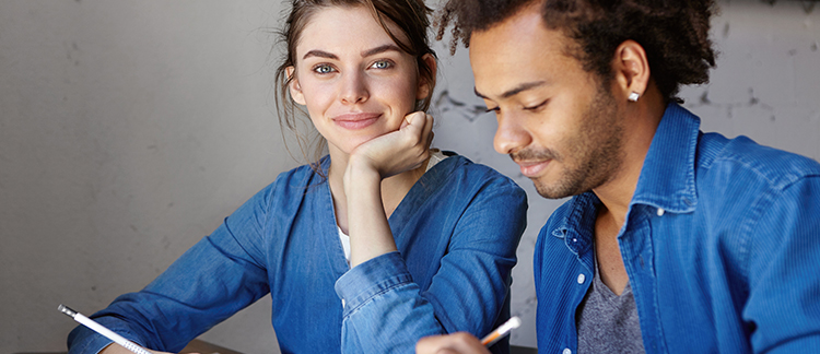 A woman and man writing