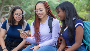 Three LSC-Tomball Students Chatting on a bench 