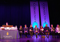 Phi Theta Kappa induction ceremony is held in the PAC each year. Dramatic blu lights shoot up on either side of a table arranged with awards.