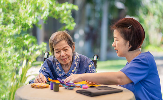 Two elderly women doing arts and crafts