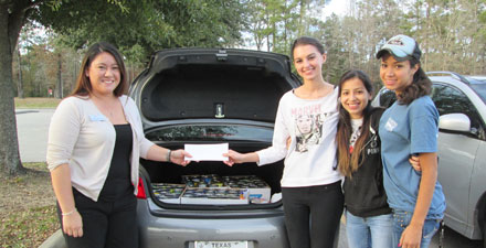 students in front of a car