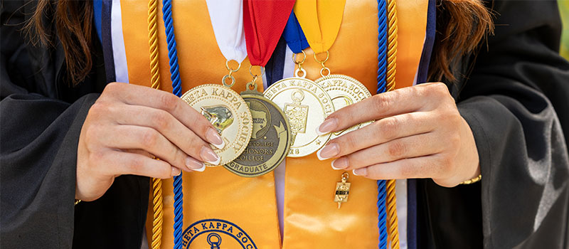 female student holding medals