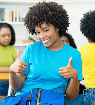 Transfer Student giving thumbs up to receiving scholarships