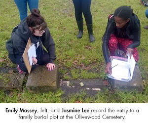 Emily Massey, left, and Jasmine Lee record the entry to a family burial plot at the Olivewood Cemetery.