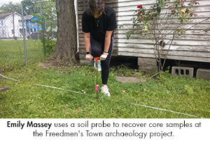 Emily Massey uses a soil probe to recover core samples at the Freedmen's Town archaeology project.