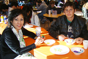 LSC-Montgomery employee Ana Marie Colchado and student sitting at a table painting.