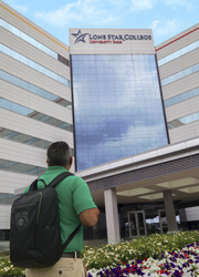 student looking at LSC-UP campus building