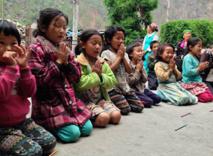 Orphanage kids kneeing in a row