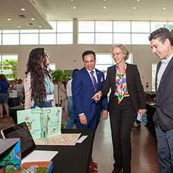 photo of judges examining a student poster project