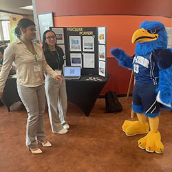 photo of Cy greeting two students