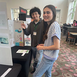 photo of two students looking at a poster project