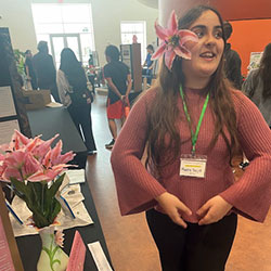 Photo of a student handing out flowers